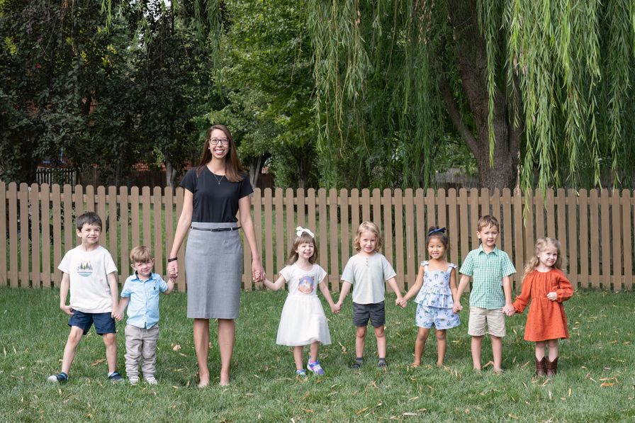 Teacher/Guide Emily with seven students holding hands